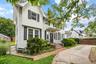 Front of Structure – Elegant front exterior showcasing timeless architectural design, steep gabled rooflines, mature landscaping, and a welcoming cove
