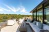 View of rooftop terrace with an outdoor kitchen and a water view