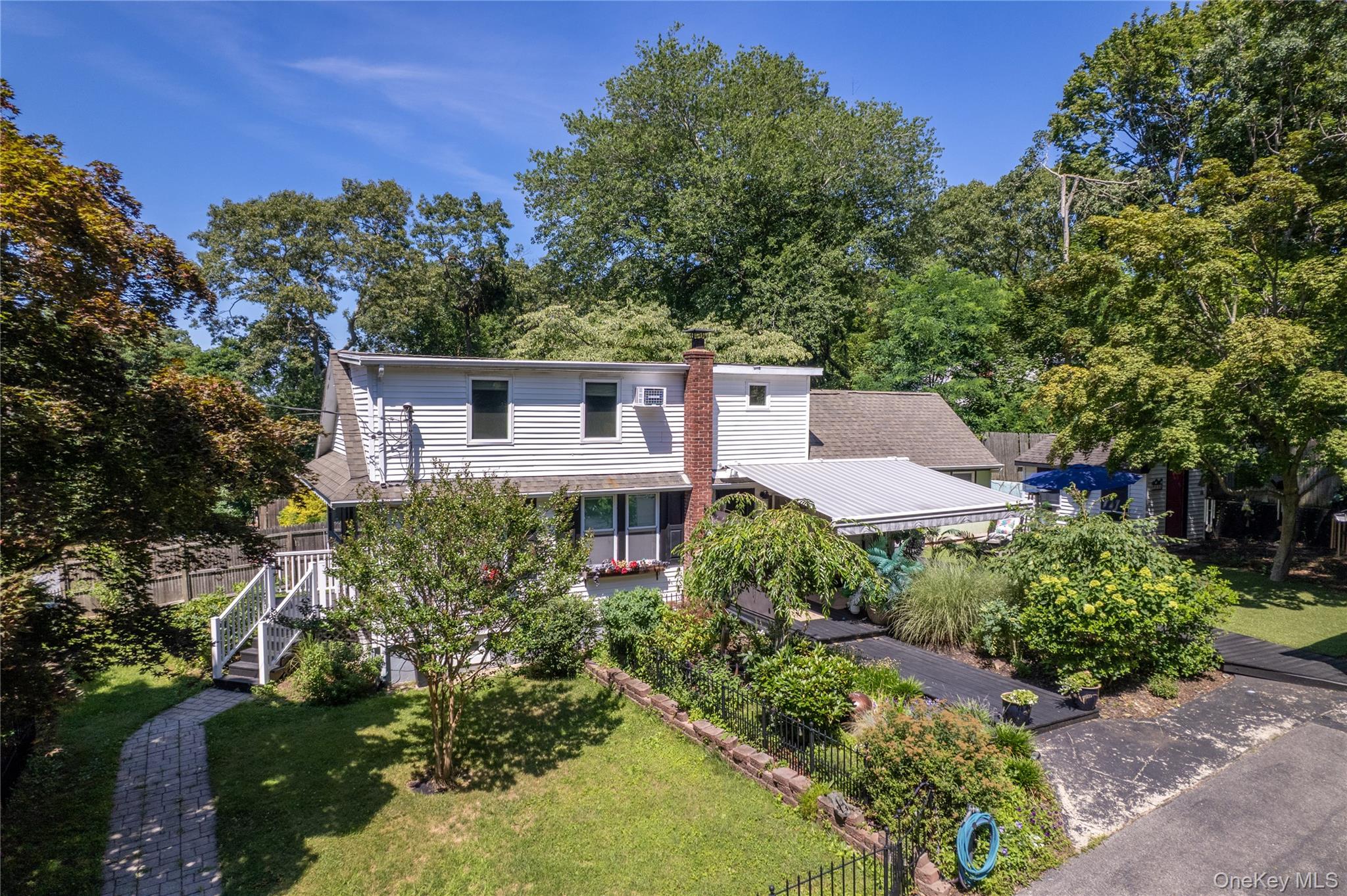 Extensive flowering gardens surround this unique property