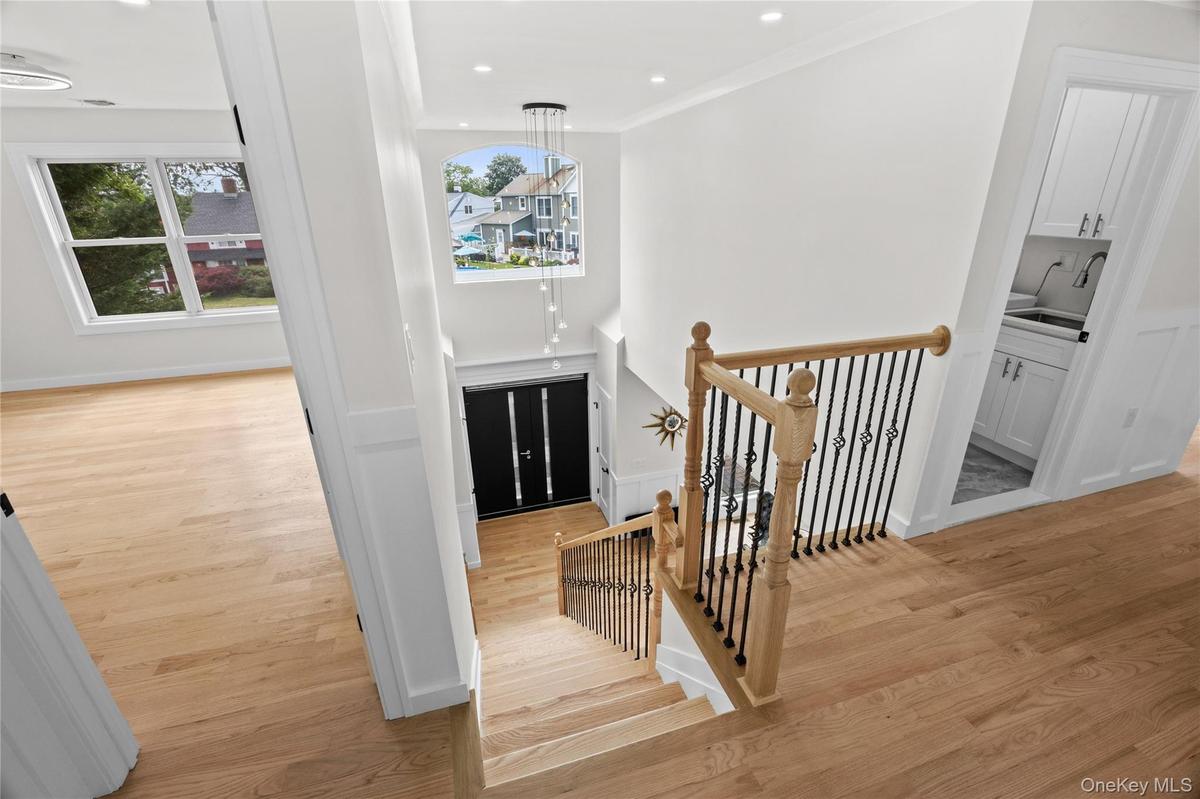 Grand Entry with 2 coat closets, custom woodwork front door header, chandelier lowering mechanism for easy cleaning!