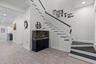 Foyer and stairs to second level. Large walk-in storage and guest bath just beyond stairs. Open kitchen beyond that.