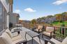 Wooden terrace with an outdoor hangout area, a residential view, and grilling area