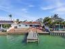 Drone photo of the back of 4 Bellevue looking north at the seawall, dock and rear of the home.