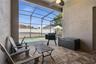 Paved covered patio overlooking the pool and fully fenced backyard