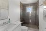 Full bathroom featuring toilet, a stall shower, and vanity