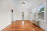 Bright and sunny dining area leads to rear screened in porch.  Air conditioner in the wall.