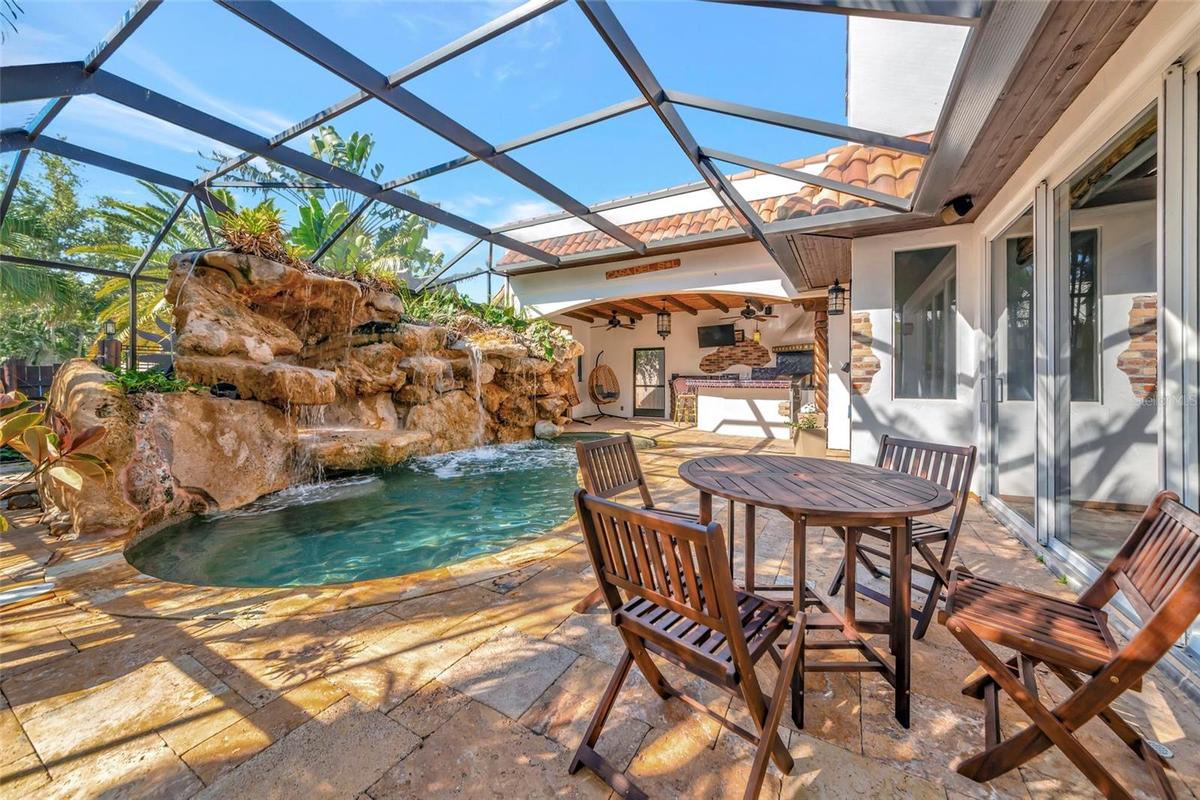 Private caged pool with seating area