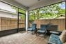 Screened lanai offering a comfortable outdoor living space, perfect for relaxing or entertaining year-round.