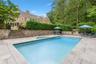 View of pool featuring a patio, stairs, and a pool with connected hot tub