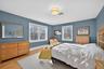 Bedroom with light wood-style floors and baseboards