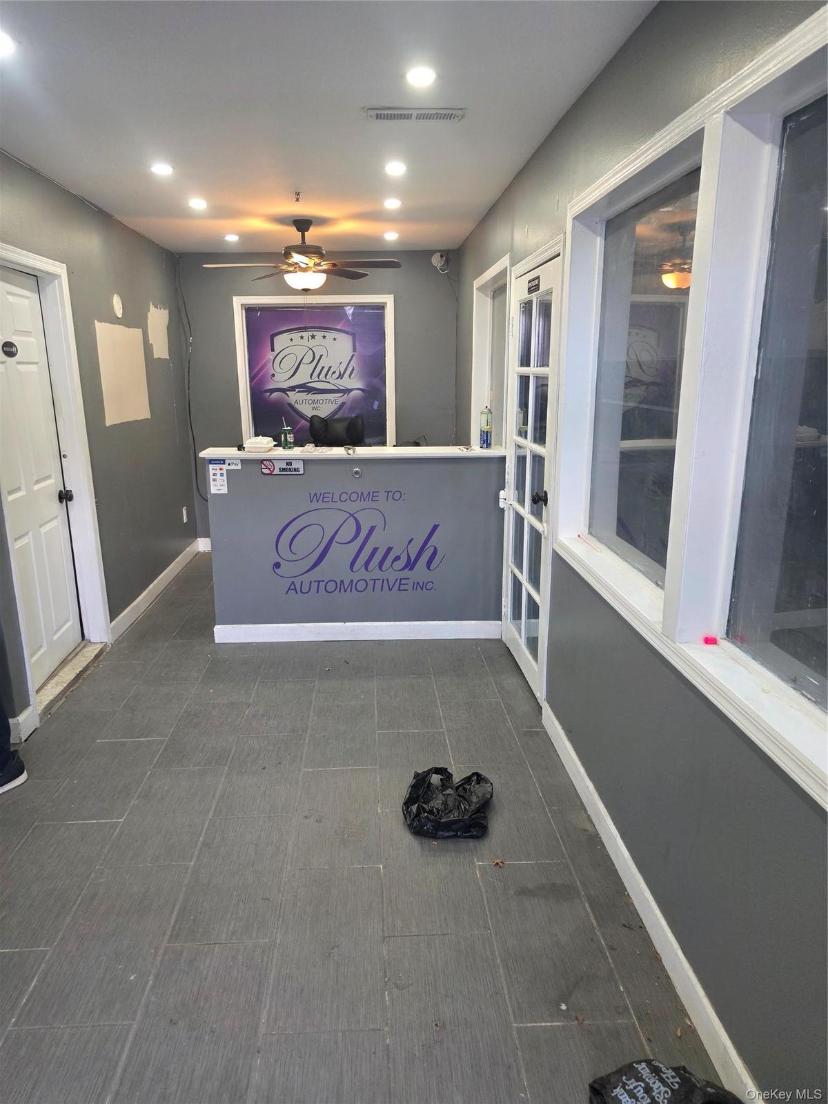 Reception area featuring a built-in counter, recessed ceiling lighting, and a ceiling fan