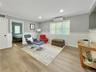 Sitting room featuring a wainscoted wall, ornamental molding, wood finished floors, recessed lighting, and a wall unit AC