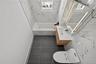 Bathroom with vanity and tile walls