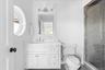 Bathroom with vanity, a shower stall, and crown molding