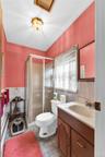Bathroom featuring a shower stall with sliding glass doors, a vanity with a built-in sink, and a toilet