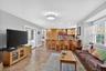 Living area with stone tile flooring, recessed lighting, and healthy amount of natural light