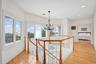 Corridor featuring an upstairs landing, Ocea. views, crown molding, light wood-style flooring, a chandelier, and recessed lighting