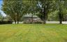 View of yard featuring a deck and view of scattered trees