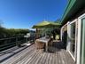 Wooden terrace with outdoor dining area and grilling area