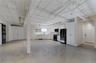 Below grade area featuring freestanding refrigerator and a barn door