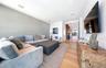 Living area with light wood-style floors and recessed lighting