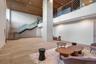 Common area featuring a towering ceiling, stairway, and recessed lighting