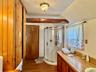 0 - hallway Bathroom featuring wood finished floors and a shower stall