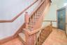 Stairway with tile patterned floors and baseboards