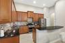 Granite counters, tiled backsplash and breakfast bar featured in the kitchen