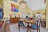 Dining area featuring high vaulted ceiling, wood finished floors, recessed lighting, and a chandelier