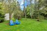 View of grassy yard featuring a storage shed