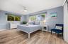 Primary bedroom with lots of windows for natural light