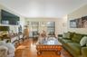 Living room with baseboard heating and wood finished floors