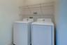Utility room with full size washer and dryer and shelving
