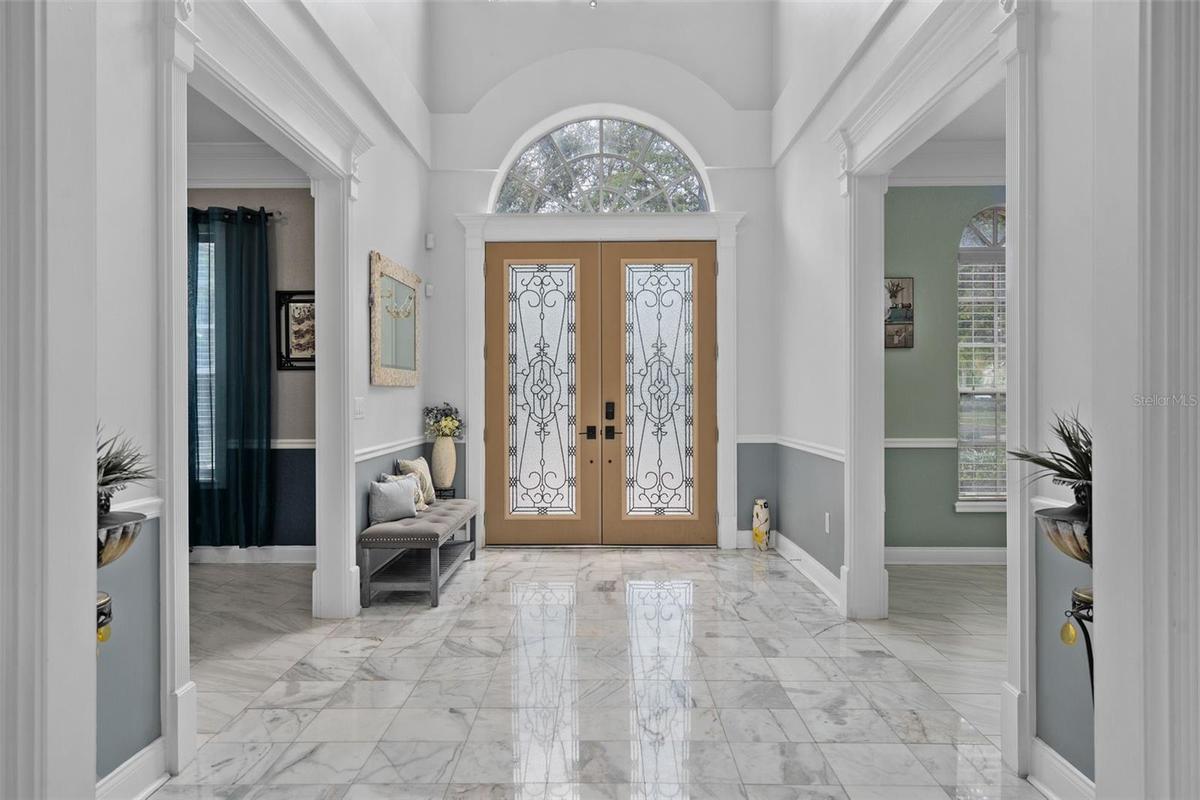 Grand Foyer entrance with beautiful marble entry floor and custom doors