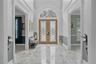 Grand Foyer entrance with beautiful marble entry floor and custom doors