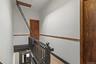 Stairway with wood finished floors and baseboards