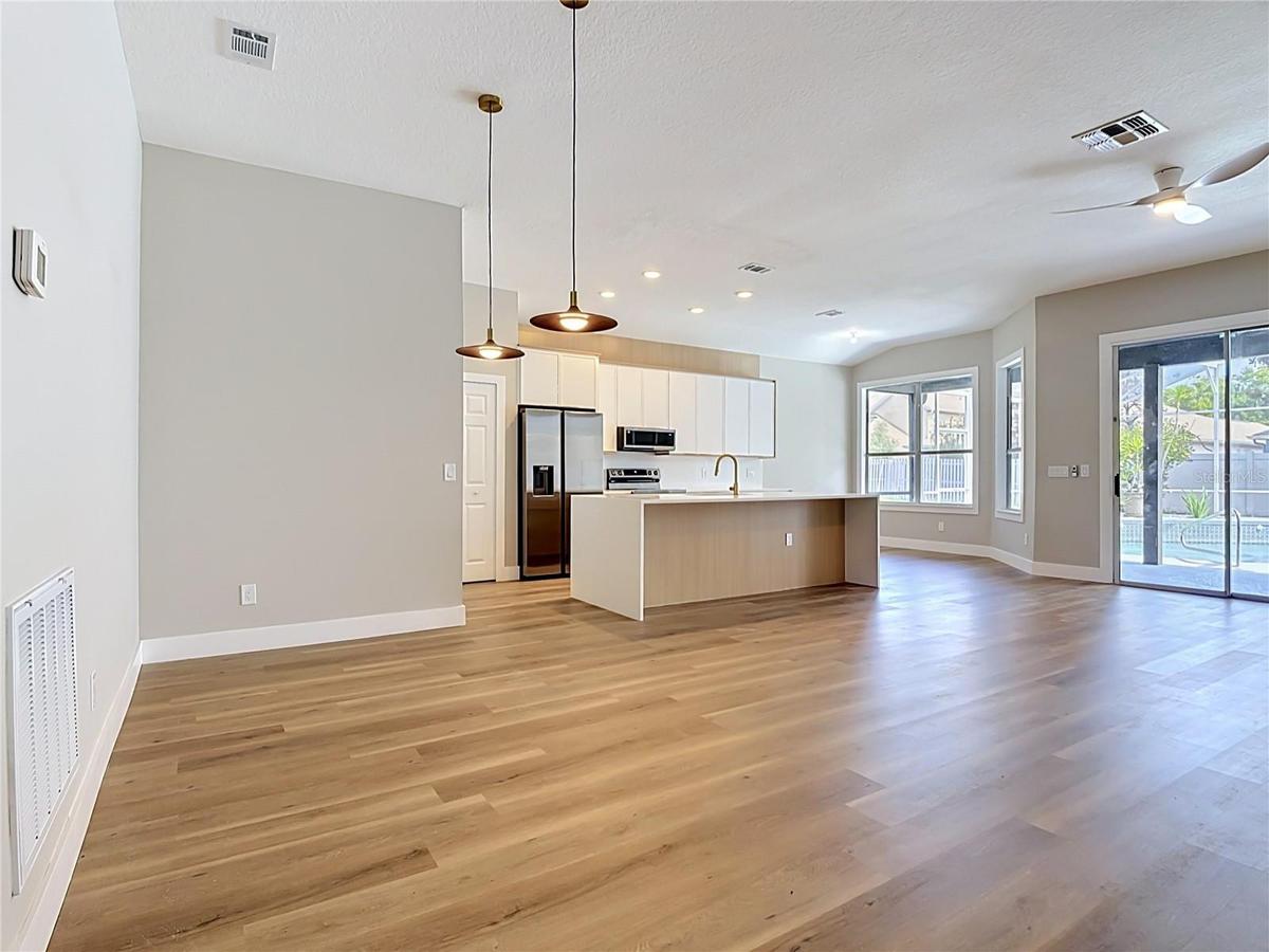 bright open-concept layout with new vinyl flooring, a fully renovated kitchen