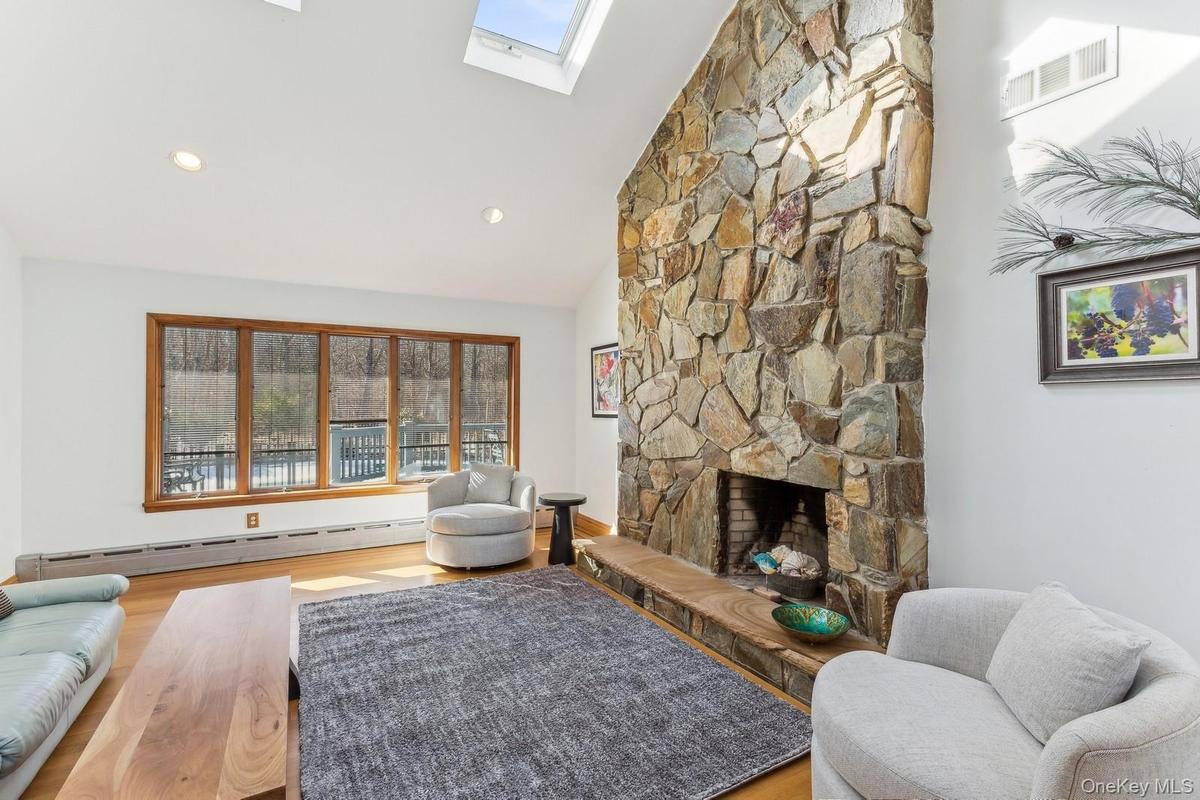 Living Room with Vaulted Ceiling and Fireplace - Photo 2