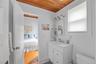 Ensuite bathroom with vanity, wood ceiling, and light tile patterned flooring