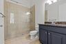 Full bathroom with glass enclosed shower.