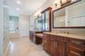 Primary Bathroom with dual granite vanities, Spacious Walk-In Shower with 7 heads and detachable hose and a large, separate tub