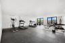 Workout area with baseboards and expansive windows