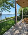 Wooden deck with a yard and a water view