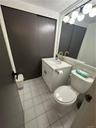 Bathroom with tile flooring, vanity, and toilet