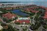 Aerial view of the front of The Grand Bellagio clubhouse, pool and bayou/inlet out into Old Tampa Bay