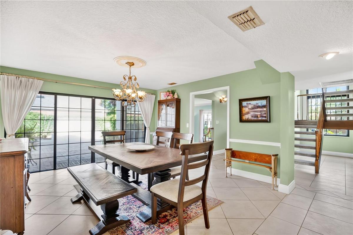 The formal dining room leads to an outdoor courtyard and fountain.