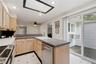 Kitchen Showcasing Skylight over Sink and view of Deck to Backyard