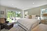 Bedroom with access to outside, multiple windows, and recessed lighting