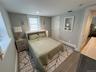 Bedroom with wood tiled floors and baseboards